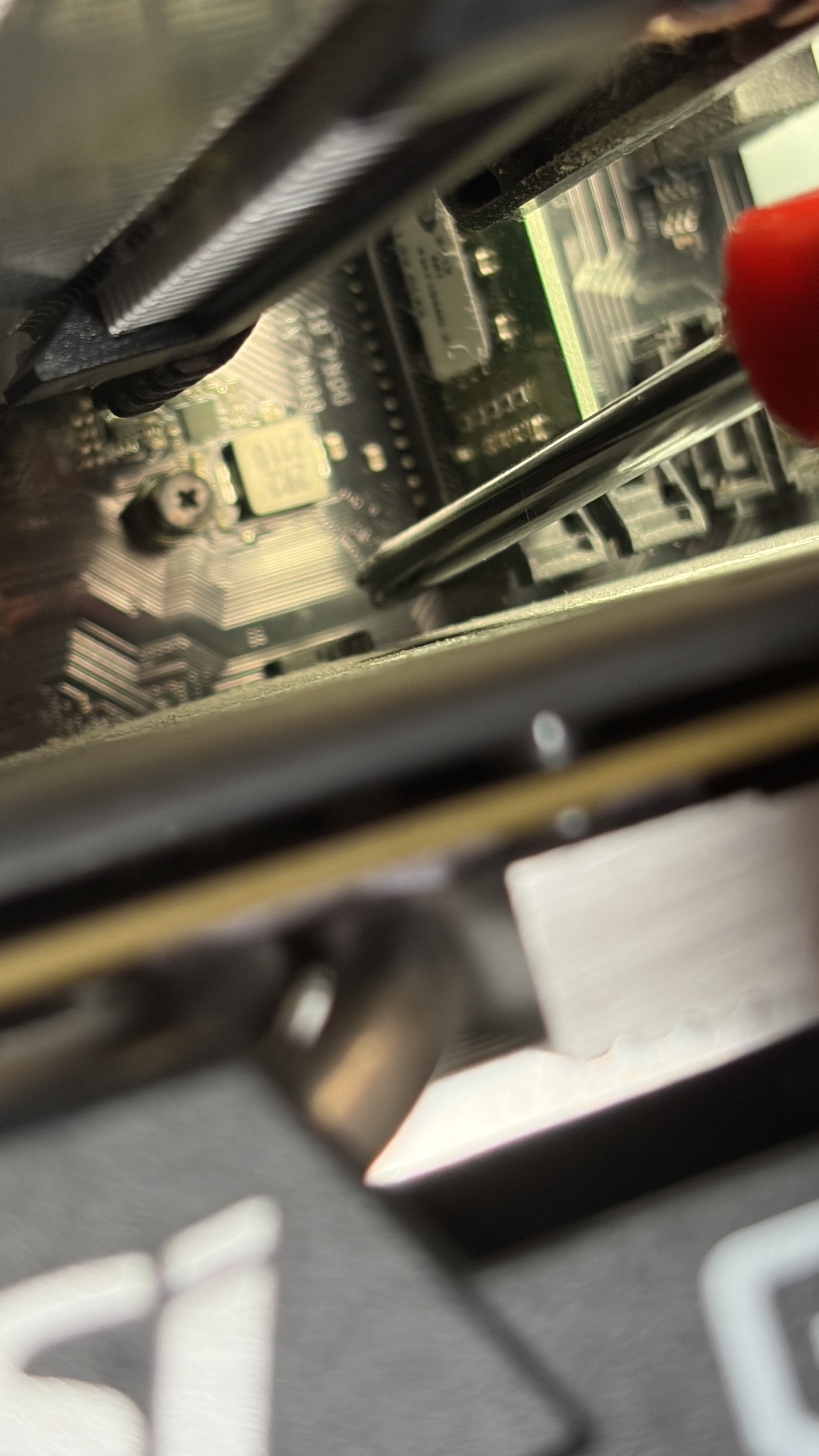 PCIeスロットのアップ。GPUのPCBが基板に密着していて、ロックレバーへのアクセスが極端に難しい。